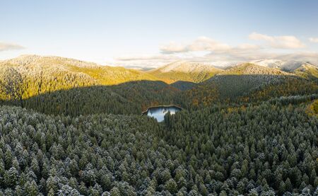 big lake in the middle of mountains during autumnの写真素材