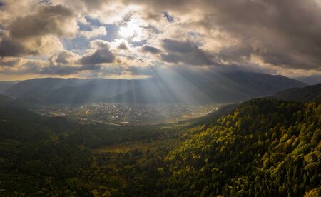 Beautiful Autumn forest shining at sunset. Flying above Colorful mountain floraの写真素材