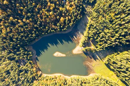 big lake in the middle of mountains during autumnの写真素材