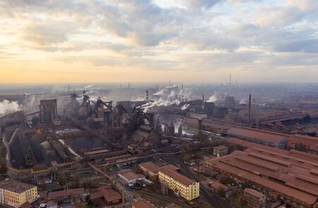 Aerial view. Pipes Throwing Smoke in the Sky. Large Plant on the Background of the City.の写真素材