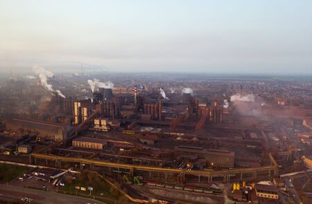 Aerial view. Pipes Throwing Smoke in the Sky. Large Plant on the Background of the City.の写真素材