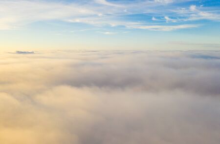 Flying over the evening clouds with the late sun.の写真素材