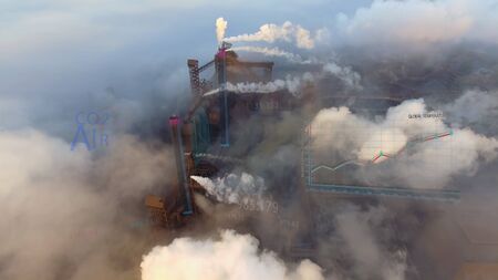 Aerial. View of high pipes with grey smoke with temperature change animationの写真素材