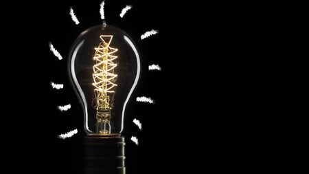 idea light bulb Flickering Tungsten light bulb lamp over black backgroundの写真素材