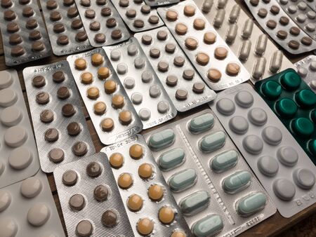 Closeup shot of different pills on table with tablets , pharmaceutical industry conceptの写真素材