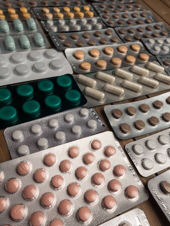 Closeup shot of different pills on table with tablets , pharmaceutical industry conceptの写真素材
