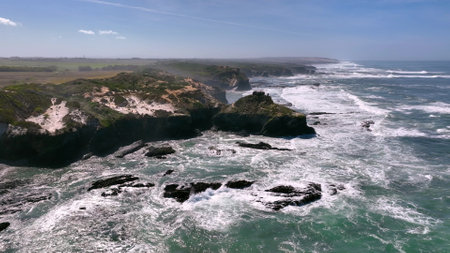 Aerial footage of the cliffs and beach in Portugal. Rota Vicentina. Slow motion oceanの写真素材
