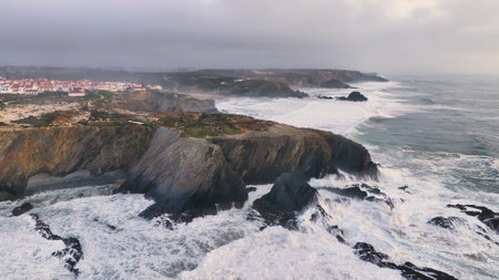 Aerial footage of the cliffs and beach in Portugal. Rota Vicentina. Slow motion oceanの写真素材