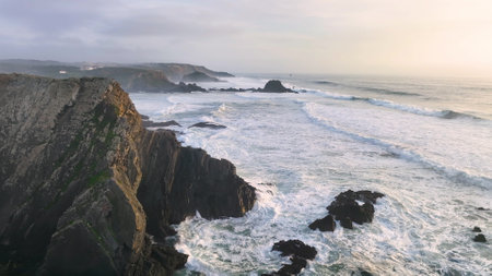 Aerial footage of the cliffs and beach in Portugal. Rota Vicentina. Slow motion oceanの写真素材