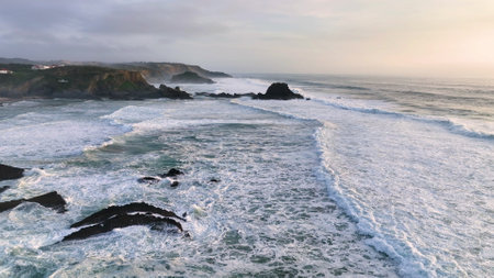 Aerial footage of the cliffs and beach in Portugal. Rota Vicentina. Slow motion oceanの写真素材