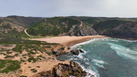 Aerial view of the Waves in the Atlantic Ocean at the Carrapateira. red mountains and Algarve coast Travel Europe Portugalの写真素材