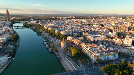 Aerial drone footage of the Seville city the Guadalquivir canal with the cathedral, the Torre del Oro, the tower of gold, Andalusia, Spaineの写真素材