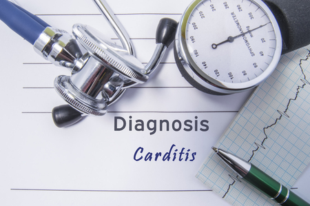 Cardiac diagnosis Carditis. Medical form report with written diagnosis of Carditis lying on the table in doctor cabinet, surrounded by stethoscope, tonometer and ecg. Concept for cardiologyの写真素材