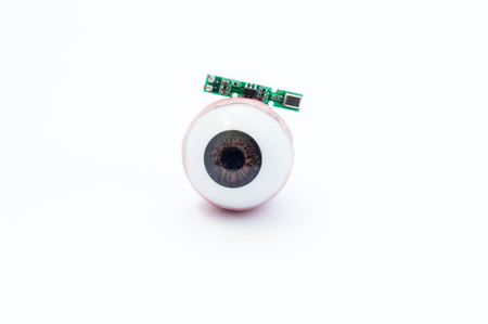 Anatomical model of human eye or eyeball with digital artificial microchip on white background. Treatment of vision loss, blindness, eye diseases using advanced digital bionic technology  implantの写真素材