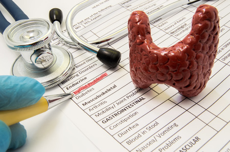 Thyroid problems concept photo. Doctor points in diagnosis process to inscription thyroid problems...