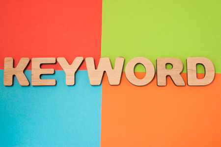 Keyword in search engine optimization SEO, advertising, digital marketing concept photo. 3D letters form word Keyword, part of Internet marketing in 4 colors background : blue, green, orange and redの写真素材