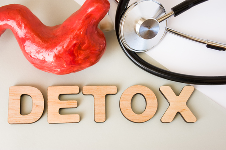 Stomach detox concept photo. Word detox of volumetric letters is near 3D stomach model and medical stethoscope. Medical diet program for detoxification and cleanse of gastric for women and menの写真素材