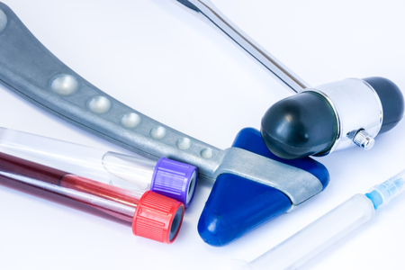 Set of diagnostic equipment of neurologist or general practitioner includes two neurological reflex hammer syringe, blood and cerebrospinal fluid tests after  lumbar spinal puncture in laboratory tubeの写真素材