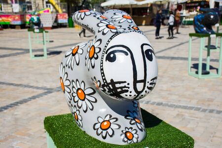 3D big gray statue of a hare or a rabbit, painted with daisies, drawn by a white muzzle. Beautiful art easter decoration .Kyiv (Kiev), Ukraine, april 2018のeditorial素材