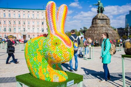The figure of a rabbit or hare in the guise of the chameleon against the background of monument to Bohdan Khmelnytskyi. Beautiful Easter decoration artのeditorial素材
