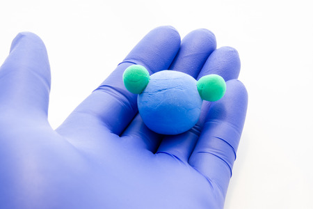 Scientist, researcher or teacher holding model of chemical formula of water is composed of oxygen...