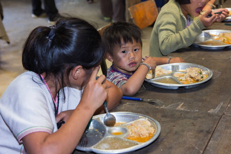 chiangmai, Thailand - November 12, 2013  unidentified poor children in Thailand have been donated food のeditorial素材