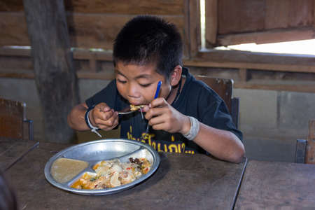 chiangmai, Thailand - November 12, 2013  unidentified poor boy in Thailand have been donated food  Poor children in Thailand  Lives of the poor  They live on a far mountain のeditorial素材