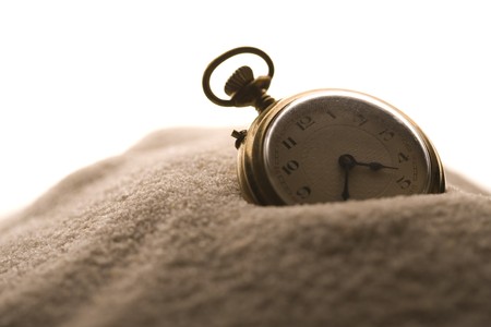 Old clock in sandの写真素材