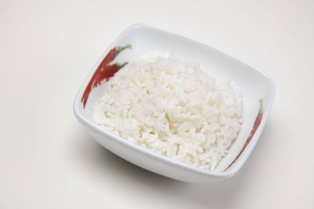 A bowl of perfectly cooked, plain Basmati rice, in an Asian style bowl, with a garnish of Thai Basilの写真素材