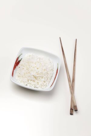 A bowl of perfectly cooked, plain Basmati rice, in an Asian style bowl, with a garnish of Thai Basilの写真素材