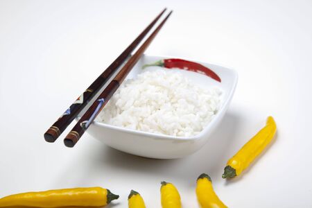A bowl of perfectly cooked, plain Basmati rice, in an Asian style bowl, with a garnish of Thai Basilの写真素材