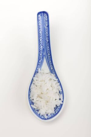 A bowl of perfectly cooked, plain Basmati rice, in an Asian style bowl, with a garnish of Thai Basilの写真素材