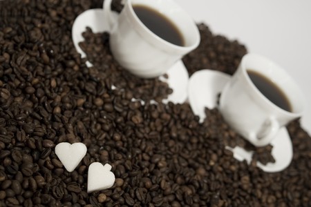 A rich cups of hot coffee, with fresh roasted beans の写真素材