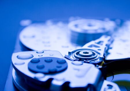 Closeup of the platters and read/write head of a computer hard drive