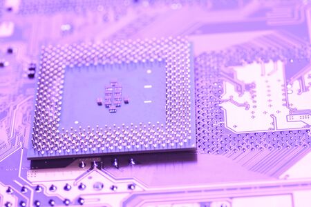 A close up shot of the backside of a computer circuit board, also known as a motherboard.