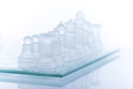 Beautiful glass chess on a white background. Photo taken in the studio on a glass countertop.の写真素材