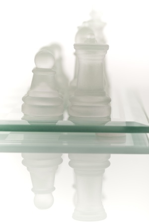 Beautiful glass chess on a white background. Photo taken in the studio on a glass countertop.の写真素材