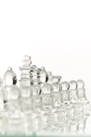 Beautiful glass chess on a white background. Photo taken in the studio on a glass countertop.の写真素材