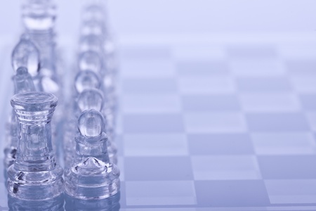 Beautiful glass chess on a white background. Photo taken in the studio on a glass countertop.の写真素材
