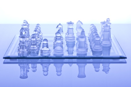Beautiful glass chess on a white background. Photo taken in the studio on a glass countertop.の写真素材