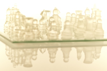 Beautiful glass chess on a white background. Photo taken in the studio on a glass countertop.の写真素材