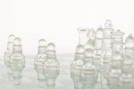Beautiful glass chess on a white background. Photo taken in the studio on a glass countertop.の写真素材