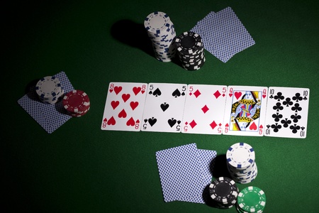 Poker cards and gambling chips on green backgroundのeditorial素材