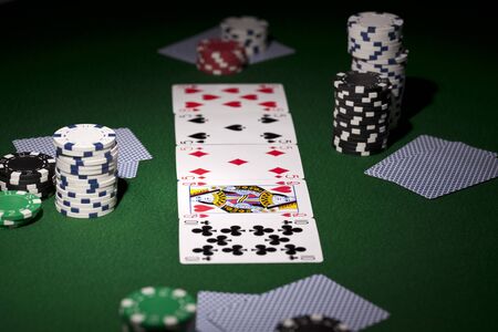 Poker cards and gambling chips on green backgroundのeditorial素材