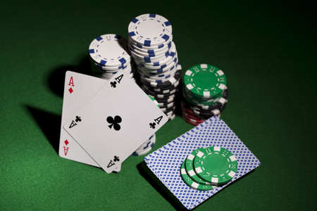 Poker cards and gambling chips on green backgroundのeditorial素材