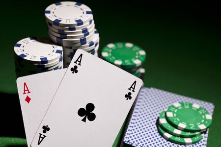 Poker cards and gambling chips on green backgroundのeditorial素材