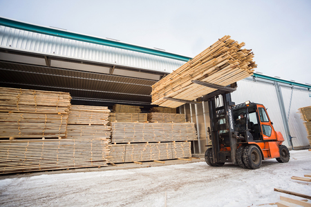 folk lift truck in wood factory or forestry timber depotの写真素材