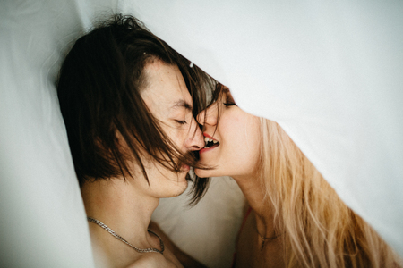 Portrait of a sexy young couple kissing.の写真素材