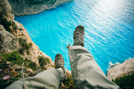 traveler sitting on a rockの写真素材