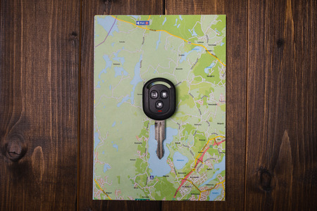 Travel concept, car key remote on the city mapの写真素材